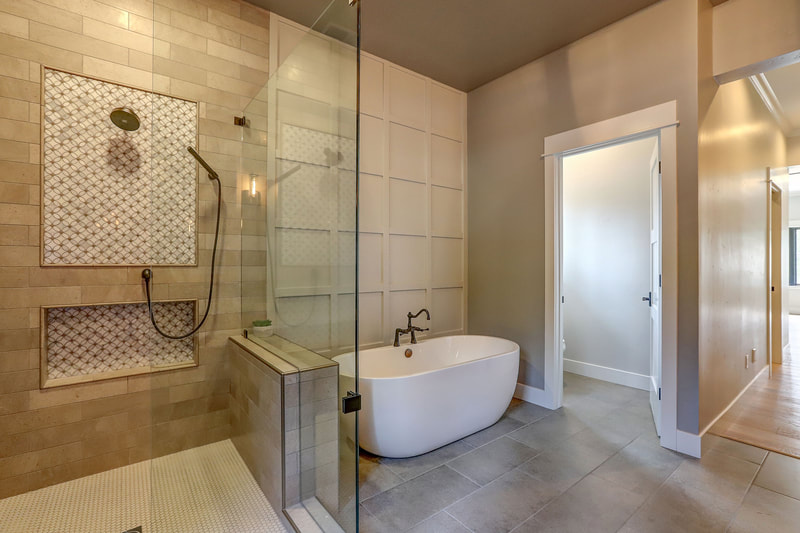 Grass Valley, CA New Home Finished Luxury Master Suite Shower and White Porcelain Stand Alone Bathtub with Bronze Plumbing Fixtures