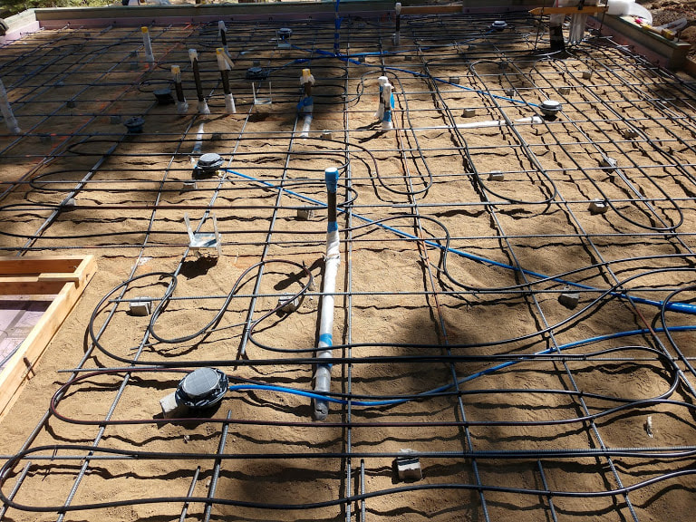 Auburn, CA High Efficiency Heat System lines laid in grid on dirt foundation.