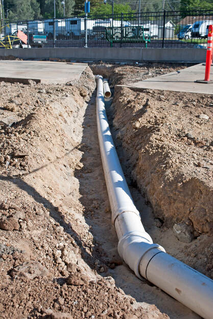 Commercial Storm Drain white drain pipe laid out in dirt ditch Grass Valley, CA