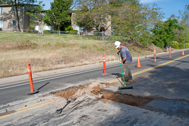 Grass Valley, CA Road Closure to Trench City Sewer Line large hole dug in street with street closure