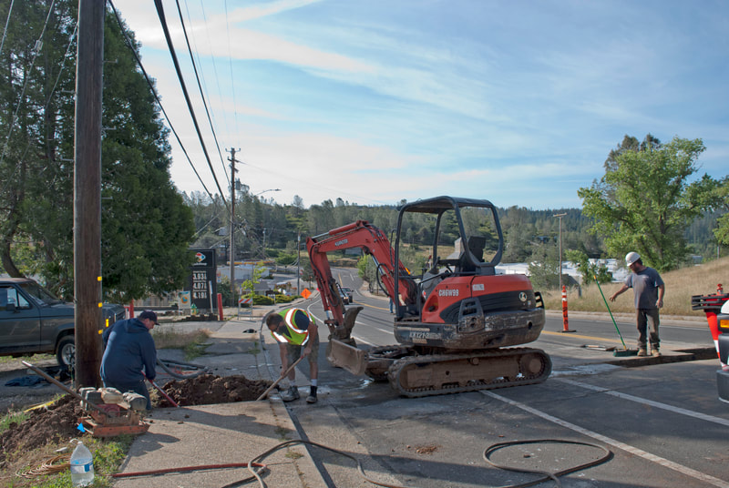 Penn Valley, CA  Excavation for Repairing Sewer Line, guys are digging up sidewalk and street