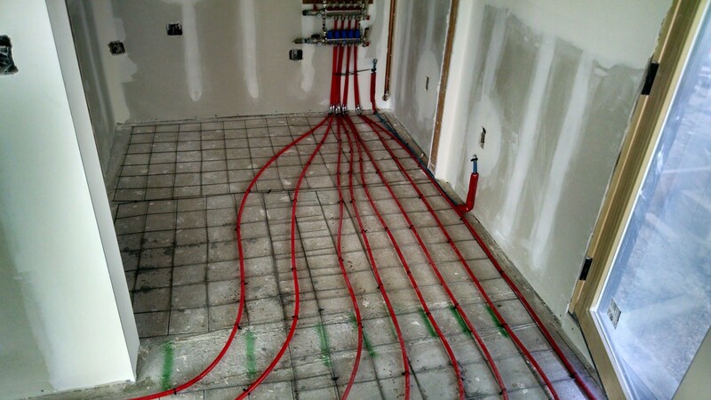 Grass Valley, CA Radiant Hydronic Heat System Installation using Red PEX pipe installed in concrete floor of home.