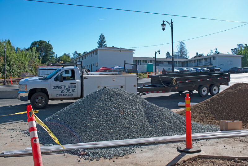Penn Valley, CA Commercial Remodel Construction Rock and Pipe unloaded for the storm drain line trenches